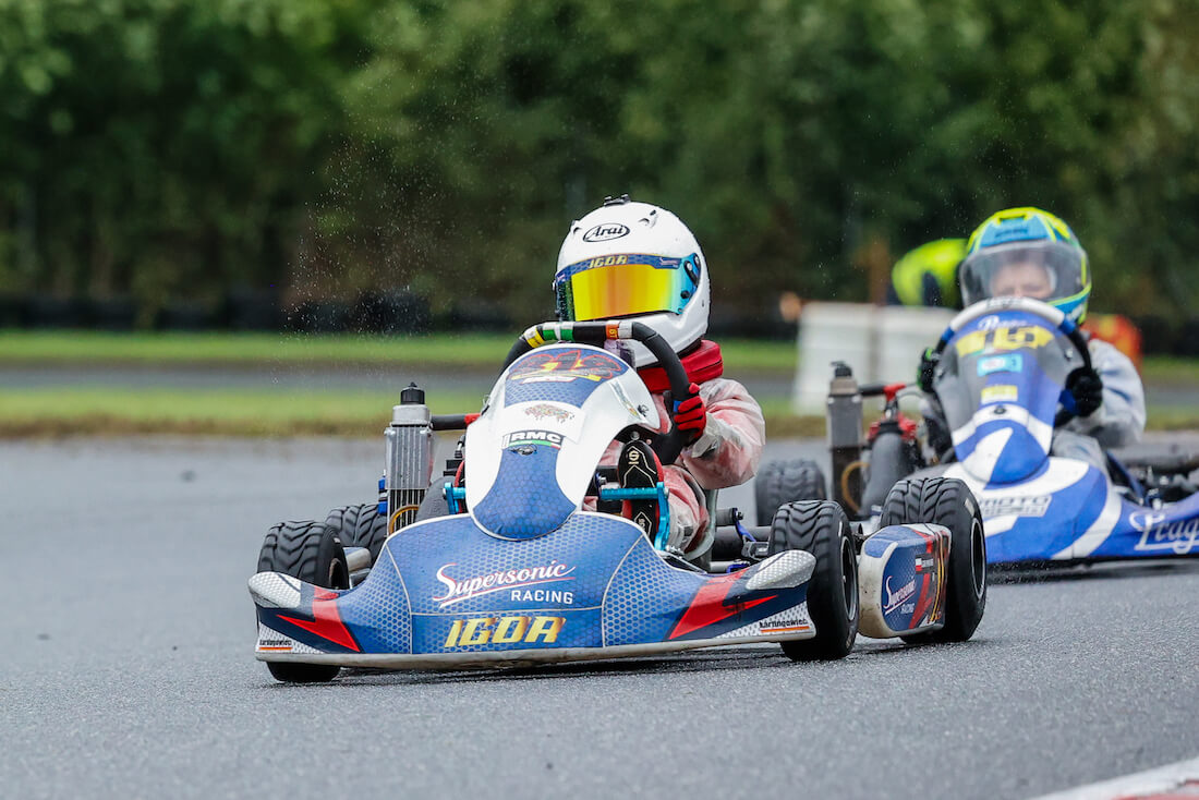 Igor Ponichtera w trakcie jazdy gokartem, w tle inni zawodnicy - Igor Racing